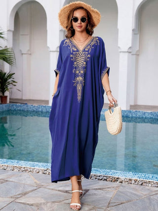 A woman wearing a Navy Short Sleeve Embroidered Kaftan.