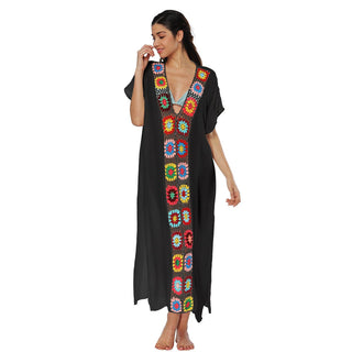 A woman wearing a black kaftan dress long.