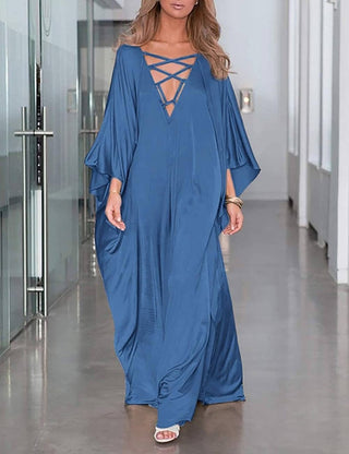 A woman wearing blue V-neck batwing sleeve kaftan.