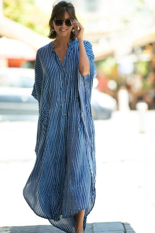 A woman wearing a casual maxi caftan dress with sun-glasses.