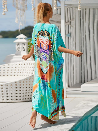 Woman wearing a colorful patterned kaftan dress at the beach.