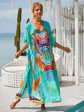 Woman wearing colorful v-neck beach kaftan dress at the beach.