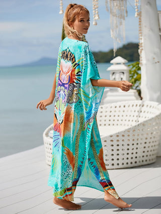 Women wearing a green v-neck beach kaftan dress at the beach.