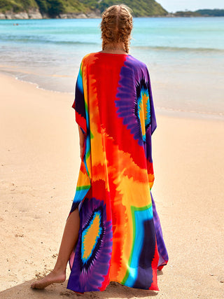 A woman wearing elegant kaftan dresses at the beach.