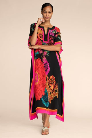 A woman wearing a floal summer maxi kaftan dress.