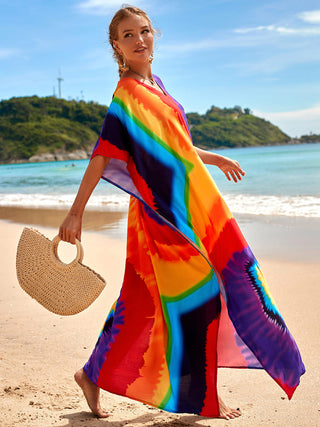 Woman wearing flower womens kaftan dress at the beach.